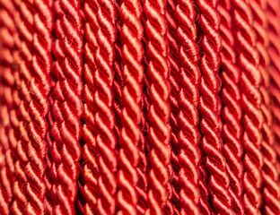 Twisted red rope strands arranged closely together showcasing texture and detail