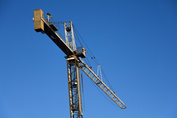 Tower Crane at Construction Site with Clear Blue Sky