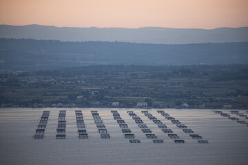 Fototapeta premium Breathtaking Sunset Over Ocean Aquaculture Platforms Enhancing Marine Ecology and Sustainability