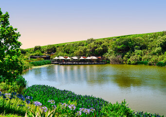 Fototapeta premium Lakeside restaurant with deck seating in Somerset West, South Africa