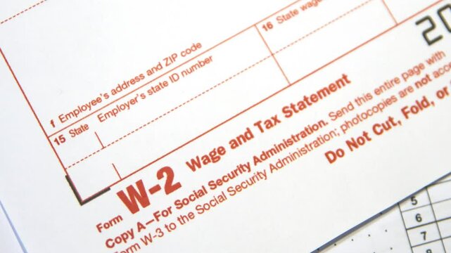 Wage and Tax Statement form Close up footage 4k. Form W-2 in red color with copy space close up.