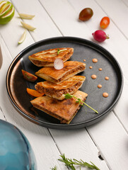 Arayes- pita bread filled with a mixture of minced meat with different spices, white wood background
