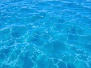 Obraz premium Clear turquoise water ripples with foamy white waves in the deep ocean, blue, ripples