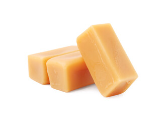 Tasty sweet caramel candies isolated on white