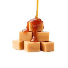 Caramel sauce dripping onto candies on white background, closeup