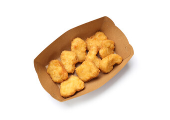 Delicious chicken nuggets in carton box isolated on white, top view