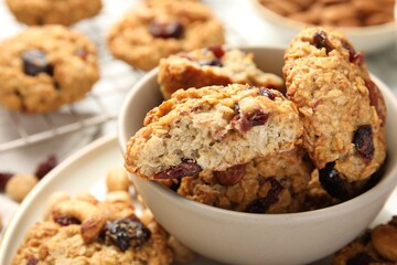 Delicious oatmeal cookies with raisins and nuts on table, closeup