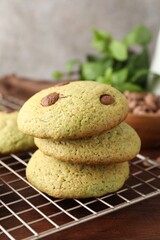 Delicious mint chocolate chip cookies on wooden table, closeup