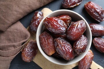 Tasty dried dates on grey table, top view