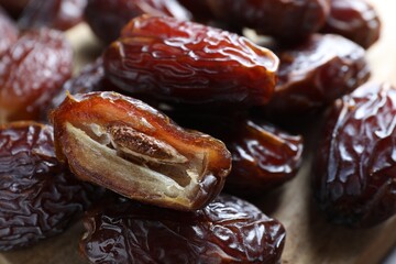 Many tasty dried dates on table, closeup