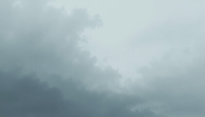 Atmospheric view of a cloudy overcast sky with varying shades of gray
