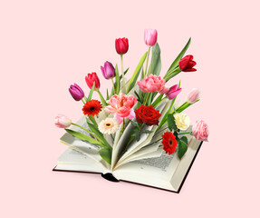 Open book with beautiful flowers between pages on pink background