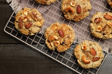 Tasty cookies with nuts on wooden table, top view