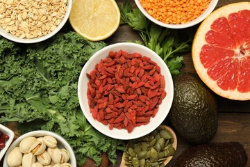 Superfood. Different healthy food products on wooden table, flat lay