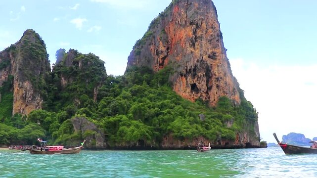 Railay Beach Thailand trip with longtail boat between limestone rocks.