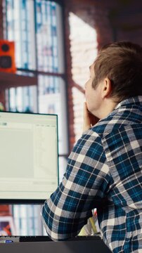Software developer at computer waiting for code to finish compiling, yawning, feeling bored. Impatient man tired to wait for algorithms building scripts to finish, camera B