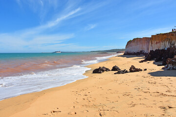 Blue and pink water on the sandy tropical beach of M&atilde;e-B&aacute; in Espirito Santo Brazil