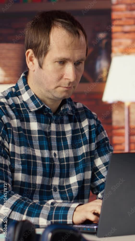 Aufkleber man seated at home office desk using laptop, checking emails displayed on screen, reading messages i