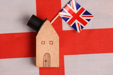 toy house with uk flag on background of flag