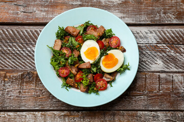 Delicious fresh tuna salad on wooden table, top view