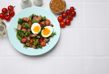 Delicious fresh tuna salad and ingredients on white tiled table, flat lay. Space for text