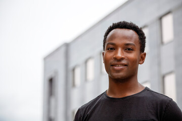 Young man smiling, big smile african Student on college campus university city life