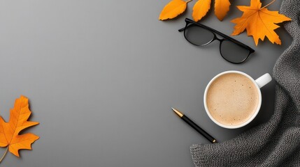 Autumn Work Essentials: Keyboard, Pen, Glasses, Coffee, and Maple Leaves on Grey Background with Copyspace