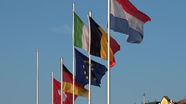 Sirmione, Italy - November 6, 2024:European flags are raised in the port. Flags