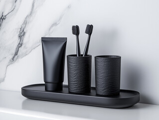 Black Toothbrush Holders, Toothpaste, and Tray on Marble Surface