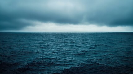 Fototapeta premium Serene Overcast Sky Above Calm Blue Ocean Waves at Dusk