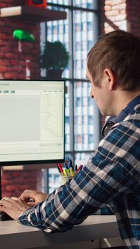 Software engineer at computer coding, creating software using isolated screen tablet. IT specialist in home office working with code editor, building applications using PC and mockup device, camera A