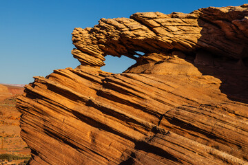 An arch made of layers of sandstone along Beehive Trail near Page, Arizona.