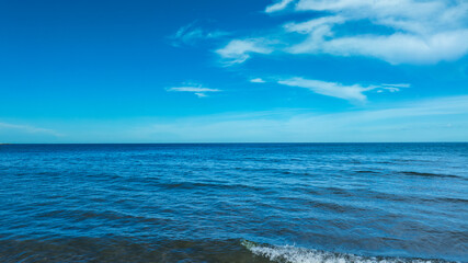 Nature of the beach and sea Summer with sunshine, sandy beaches, clear blue waters sparkling against the blue sky. On an island with good ecology and environment Background for summer vacation concept