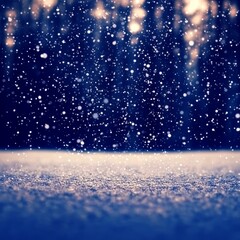 Obraz premium Snowfall over a snowy ground with blurred forest background.