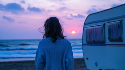 Fototapeta premium Woman enjoying the serene sunset by the beach with her mobile home, embracing freedom, nature, and a peaceful travel lifestyle in an idyllic coastal setting