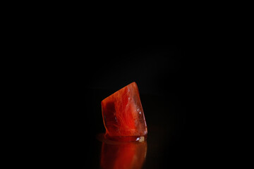 Macro texture of red color ice cube 