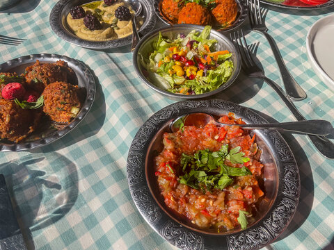 Istanbul, TR - Oct 23, 2024 A colorful spread of mezeler and salatalar: lentil balls, hummus with blackberries, roasted eggplant salad, and fresh greens&mdash;perfect for a Bosphorus cruise feast!