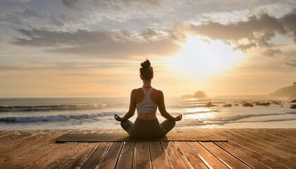 Woman yoga session on a wooden deck overlooking the ocean panorama view