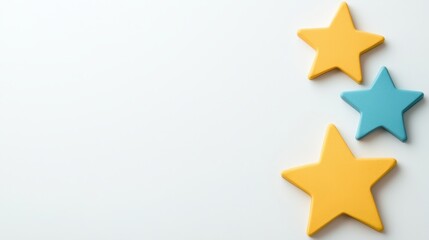 Obraz premium Three colorful star shapes in yellow and blue are arranged playfully against a soft, light background, creating a cheerful and inviting atmosphere.