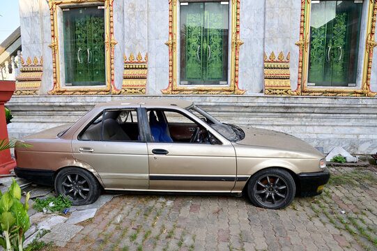 BANGKOK, THAILAND - December 15, 2024 : An old Nissan Sentra SE-R B13 car not in use parked in Thai Buddhist temple at Thailand.