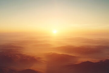 Fototapeta premium A serene sunrise over rolling hills, creating a tranquil and picturesque landscape.