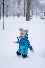 children playing in the snow in the park