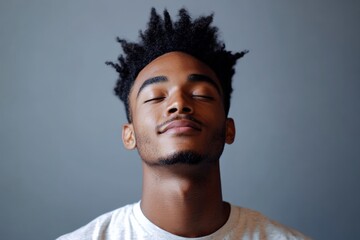 Obraz premium Portrait of a Young Man with Natural Hair, Exuding Calmness and Confidence