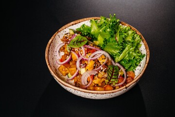 Salad with vegetables and meat on a plate