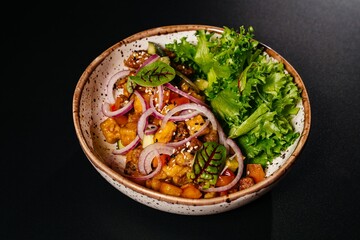 Salad with vegetables and meat on a plate