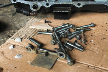 some motorcycle bolts on cardboard. motorcycle repair, engineering