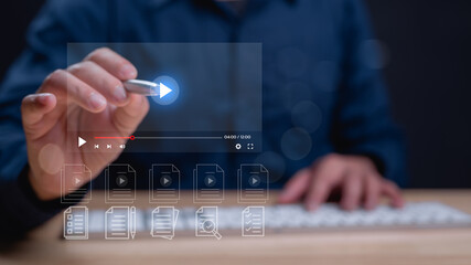 Person interacts with digital media player, highlighting increasingly digital landscape of content...