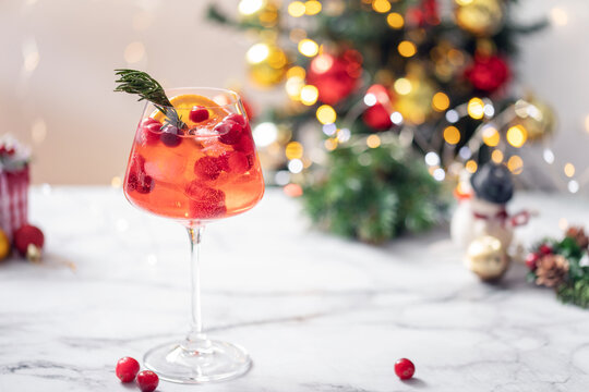 Winter Aperol Spritz. Festive alcohol drink with cranberries and orange slice  for eve christmas