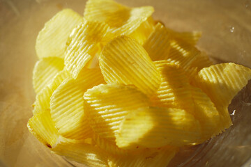 Enjoy a delightful serving of Crispy Potato Chips presented in a Bowl
