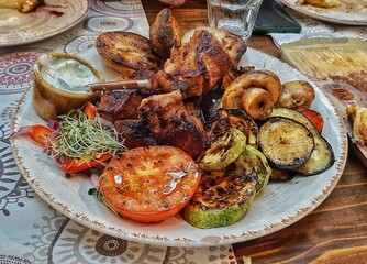 meat and vegetables are cooked on the grill